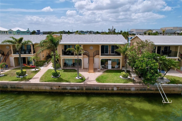 back of house featuring a patio, a water view, stairs, and a balcony