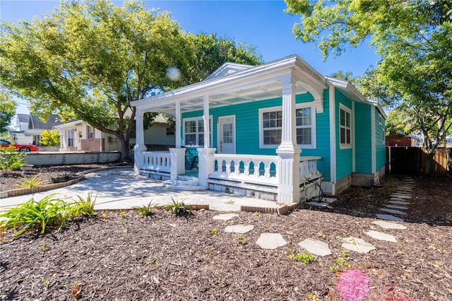 56 W Park St, Tarpon Springs, FL 34689 - view of front of property featuring a porch and fence