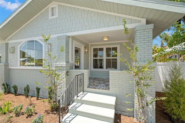 doorway to property featuring brick siding