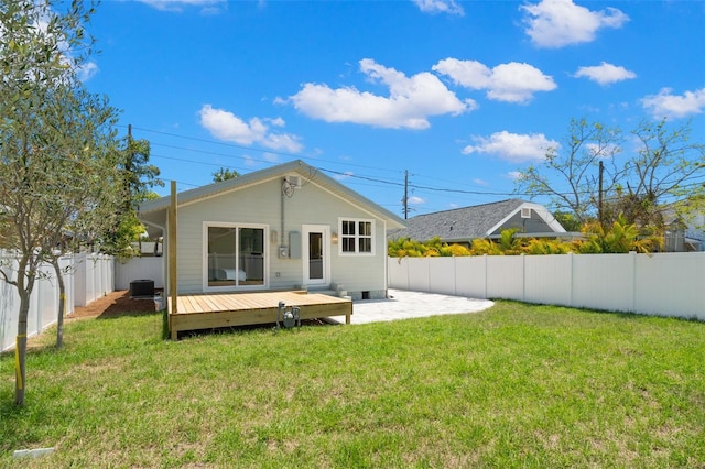 back of house with a wooden deck, a yard, a fenced backyard, and central air condition unit