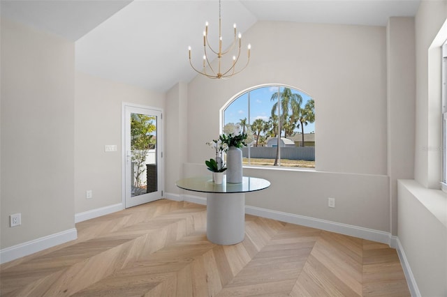 unfurnished dining area with high vaulted ceiling, a notable chandelier, and baseboards