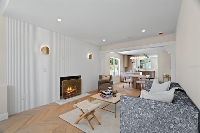 living room featuring a warm lit fireplace