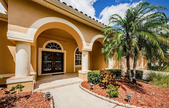 2042 Diamond Ct, Oldsmar, FL 34677 - view of exterior entry featuring french doors and stucco siding