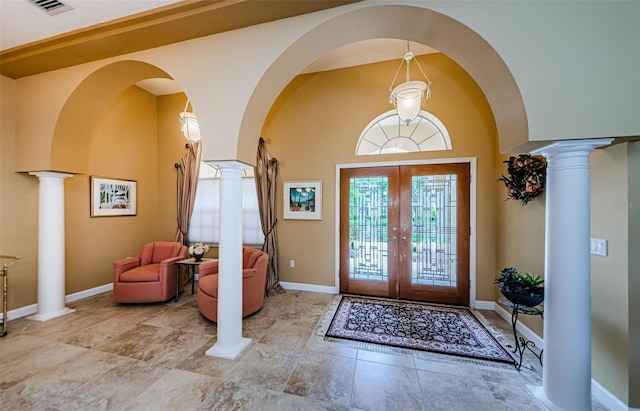 2042 Diamond Ct, Oldsmar, FL 34677 - entrance foyer featuring arched walkways, baseboards, french doors, and decorative columns