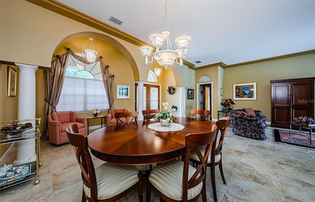 2042 Diamond Ct, Oldsmar, FL 34677 - dining space with crown molding, arched walkways, an inviting chandelier, visible vents, and ornate columns