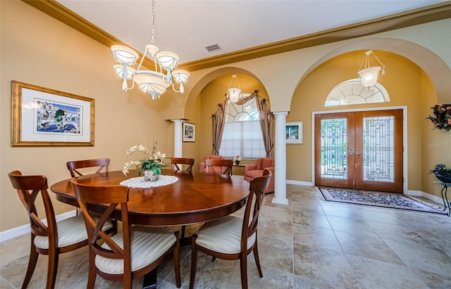 2042 Diamond Ct, Oldsmar, FL 34677 - dining space featuring arched walkways, an inviting chandelier, french doors, and ornate columns