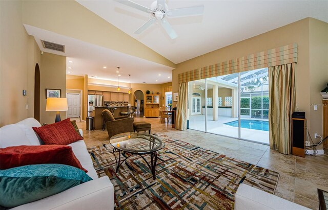 2042 Diamond Ct, Oldsmar, FL 34677 - living room featuring a ceiling fan, arched walkways, lofted ceiling, visible vents, and recessed lighting