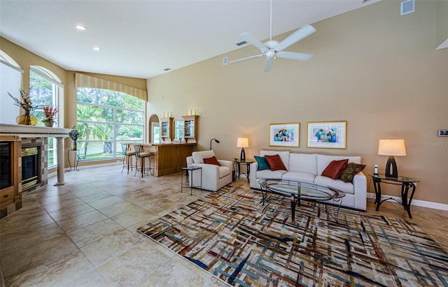 2042 Diamond Ct, Oldsmar, FL 34677 - living room with visible vents, a glass covered fireplace, baseboards, recessed lighting, and a ceiling fan