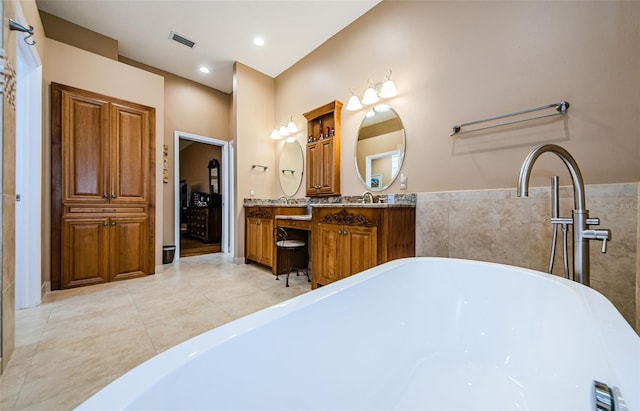 2042 Diamond Ct, Oldsmar, FL 34677 - bathroom with vanity, tile walls, a soaking tub, tile patterned flooring, and visible vents