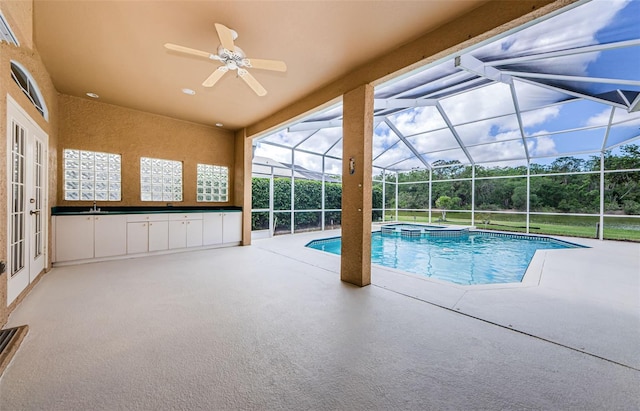 2042 Diamond Ct, Oldsmar, FL 34677 - view of swimming pool with glass enclosure, a pool with connected hot tub, a patio, and ceiling fan