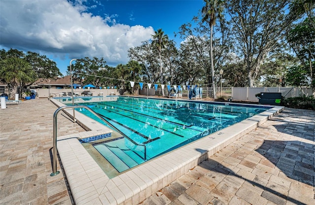 2042 Diamond Ct, Oldsmar, FL 34677 - community pool with fence, a patio area, and a grill