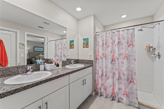 ensuite bathroom with a sink, a shower stall, and connected bathroom