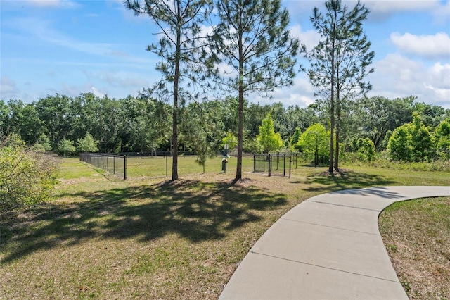 surrounding community with a lawn and fence