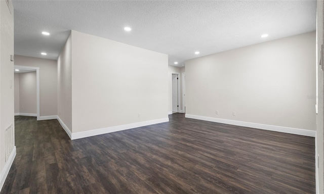 unfurnished room with recessed lighting, baseboards, dark wood-style flooring, and a textured ceiling