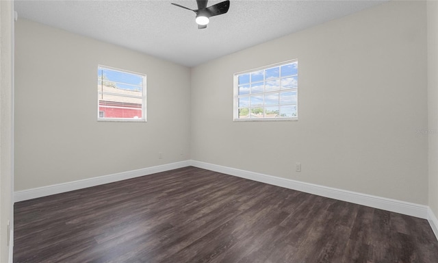 unfurnished room featuring baseboards, plenty of natural light, a ceiling fan, and dark wood-style flooring