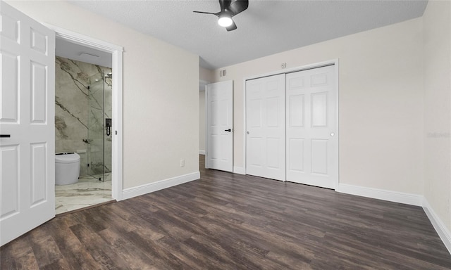 unfurnished bedroom with a closet, wood finished floors, baseboards, ceiling fan, and a textured ceiling