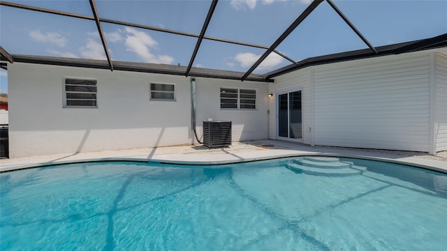 pool with central air condition unit, glass enclosure, and a patio