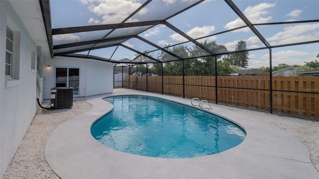view of swimming pool with central AC unit, a patio area, glass enclosure, fence, and a fenced in pool