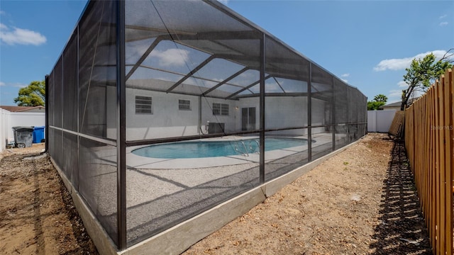 view of swimming pool featuring a fenced backyard, a fenced in pool, a patio area, and a lanai