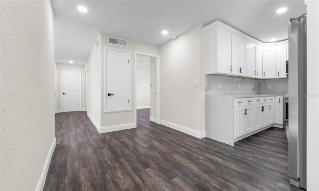 interior space with baseboards, white cabinets, and dark wood-style floors