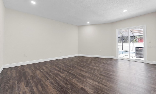 unfurnished room with recessed lighting, baseboards, and dark wood finished floors