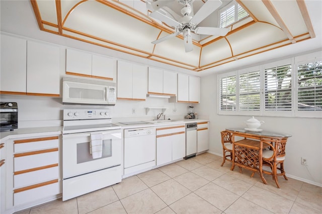 kitchen featuring light countertops, white cabinets, a ceiling fan, and white appliances