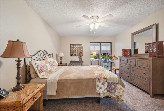 carpeted bedroom with ceiling fan and a textured ceiling