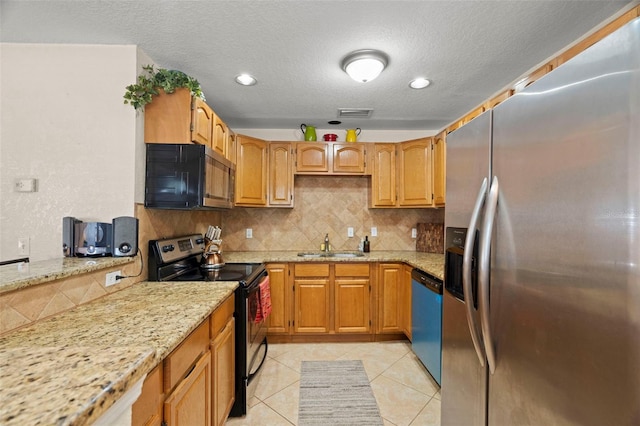 2903 W Paxton Ave, Tampa, FL 33611 - kitchen with stainless steel appliances, a sink, tasteful backsplash, light stone countertops, and a textured ceiling