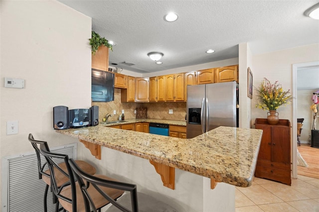 2903 W Paxton Ave, Tampa, FL 33611 - kitchen with stainless steel refrigerator with ice dispenser, a peninsula, a textured ceiling, light stone countertops, and decorative backsplash