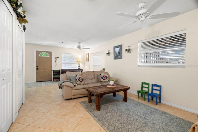 2903 W Paxton Ave, Tampa, FL 33611 - living area with a ceiling fan, light tile patterned flooring, and baseboards