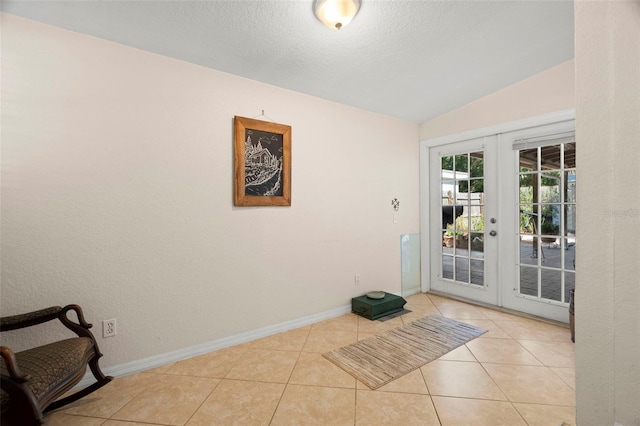 2903 W Paxton Ave, Tampa, FL 33611 - doorway to outside featuring french doors, lofted ceiling, baseboards, tile patterned floors, and a textured ceiling