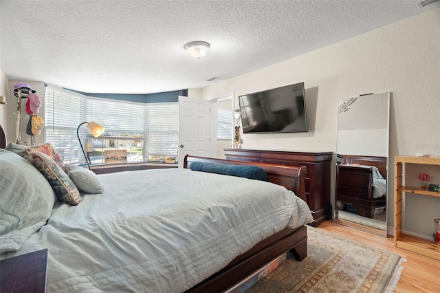 2903 W Paxton Ave, Tampa, FL 33611 - bedroom with light wood-style floors and a textured ceiling