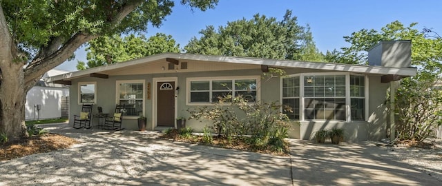 2903 W Paxton Ave, Tampa, FL 33611 - ranch-style house featuring stucco siding, a chimney, and a patio