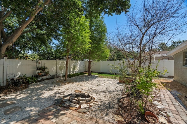 2903 W Paxton Ave, Tampa, FL 33611 - fenced backyard with an outdoor fire pit and a patio