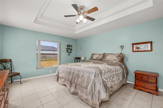 6917 Spumoni St, Sebring, FL 33872 - bedroom featuring a tray ceiling, light tile patterned floors, baseboards, and ceiling fan