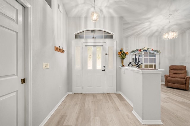 6917 Spumoni St, Sebring, FL 33872 - entryway featuring a chandelier, wood finished floors, and baseboards