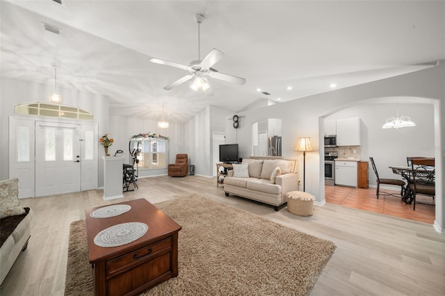 6917 Spumoni St, Sebring, FL 33872 - living area featuring a chandelier, arched walkways, recessed lighting, vaulted ceiling, and light wood finished floors