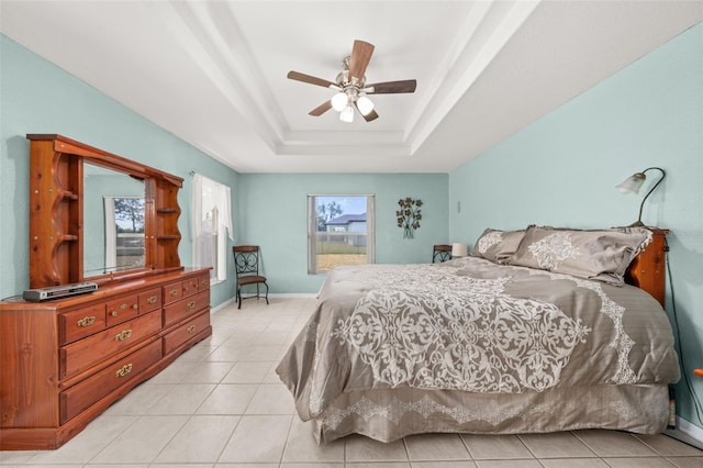 6917 Spumoni St, Sebring, FL 33872 - bedroom featuring a tray ceiling, light tile patterned floors, a ceiling fan, and baseboards