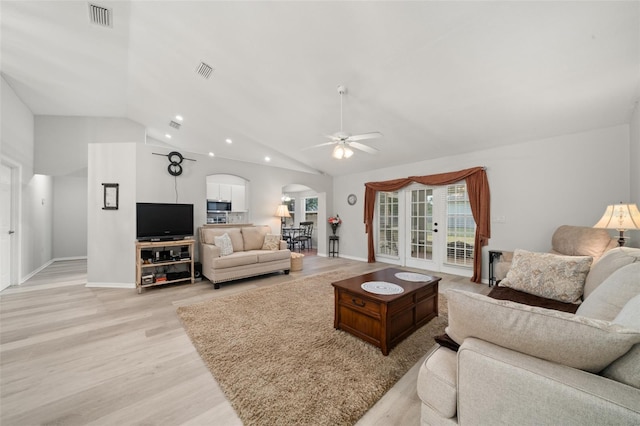 6917 Spumoni St, Sebring, FL 33872 - living area featuring arched walkways, a ceiling fan, light wood finished floors, vaulted ceiling, and baseboards
