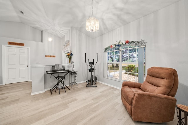 6917 Spumoni St, Sebring, FL 33872 - living area with a chandelier, lofted ceiling, light wood-style flooring, and baseboards