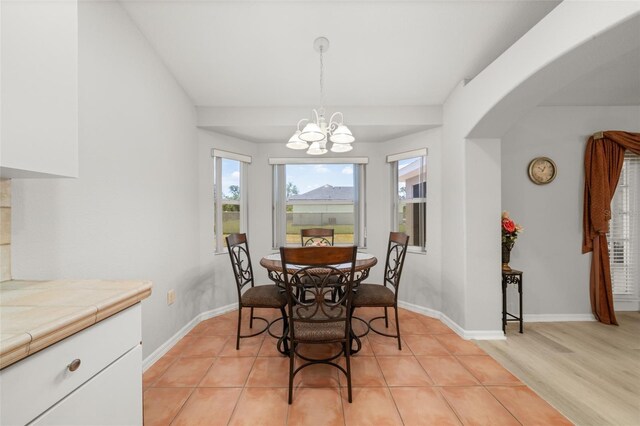 6917 Spumoni St, Sebring, FL 33872 - dining area featuring a chandelier, arched walkways, and baseboards