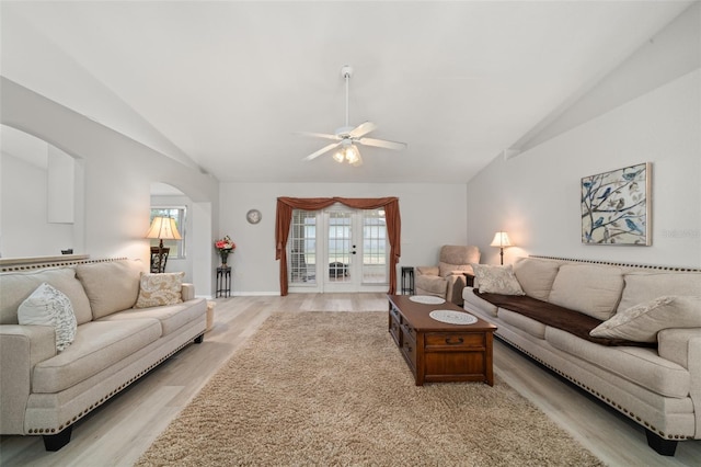 6917 Spumoni St, Sebring, FL 33872 - living room with lofted ceiling, light wood-style flooring, ceiling fan, arched walkways, and french doors
