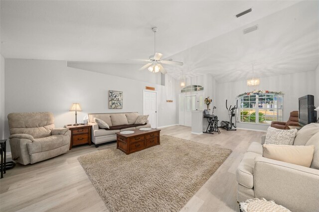 6917 Spumoni St, Sebring, FL 33872 - living room featuring light wood finished floors, a chandelier, ceiling fan, and lofted ceiling