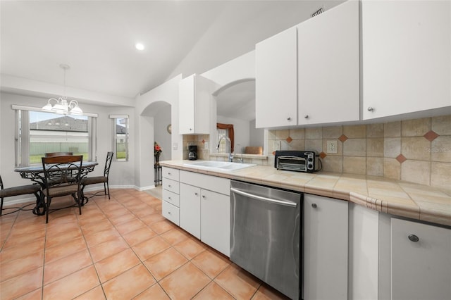 6917 Spumoni St, Sebring, FL 33872 - kitchen with stainless steel dishwasher, a sink, lofted ceiling, arched walkways, and backsplash