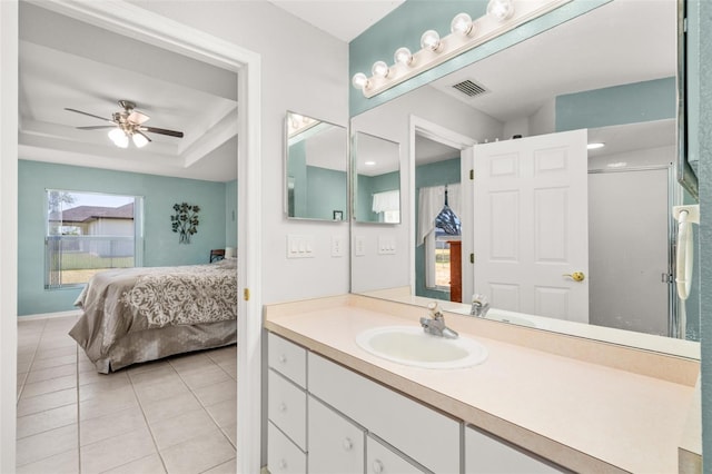 6917 Spumoni St, Sebring, FL 33872 - ensuite bathroom with vanity, tile patterned floors, ceiling fan, a shower with door, and a tray ceiling