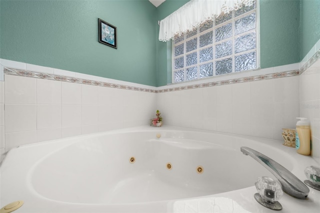 6917 Spumoni St, Sebring, FL 33872 - bathroom featuring a whirlpool tub and a textured wall