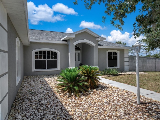 6917 Spumoni St, Sebring, FL 33872 - view of front facade with stucco siding and a shingled roof