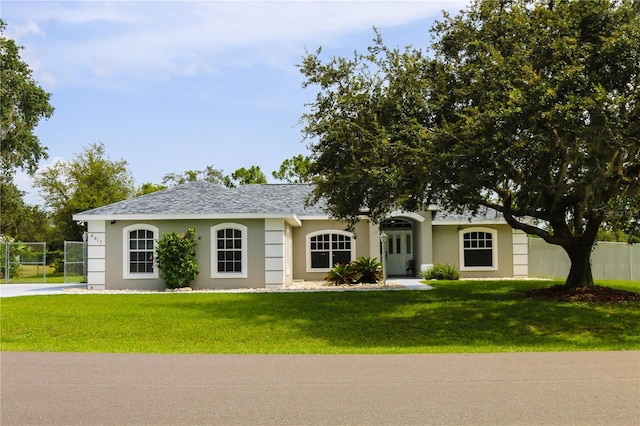 6917 Spumoni St, Sebring, FL 33872 - ranch-style home featuring stucco siding, roof with shingles, and a gate