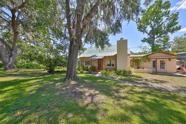 10824 Palmetto St, Riverview, FL 33569 - view of front of home with a chimney, french doors, and a front lawn