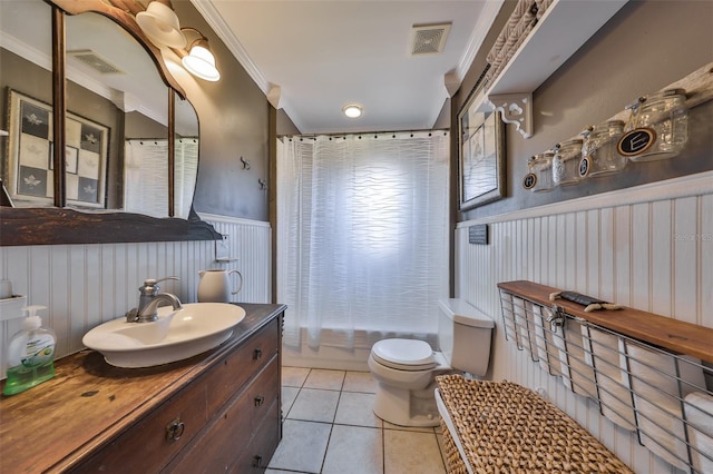 10824 Palmetto St, Riverview, FL 33569 - bathroom featuring a wainscoted wall, tile patterned floors, crown molding, toilet, and vanity